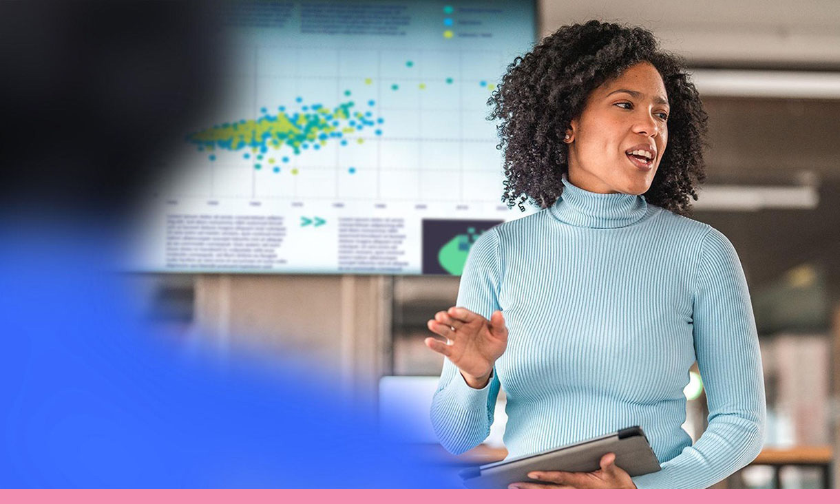 A woman presents at a meeting.