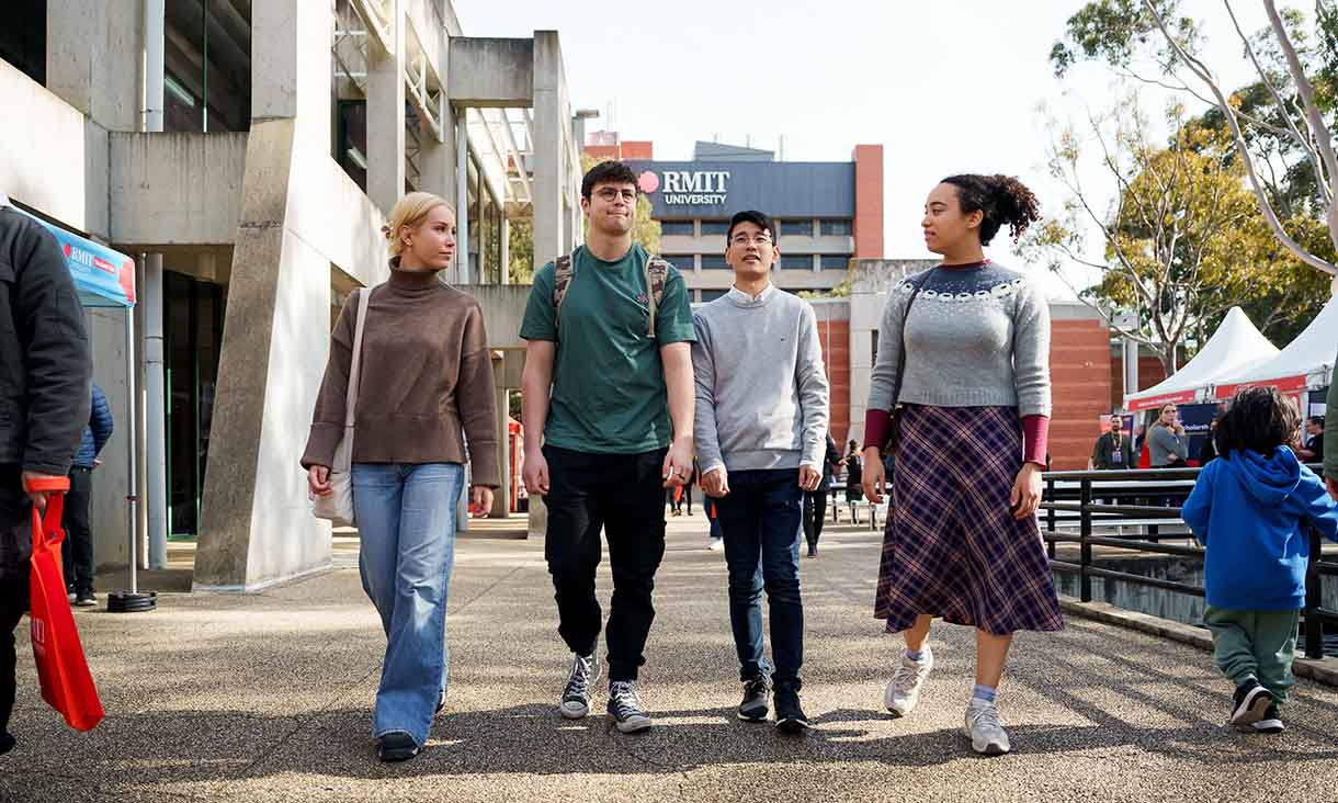  International students walking and discussing on campus.