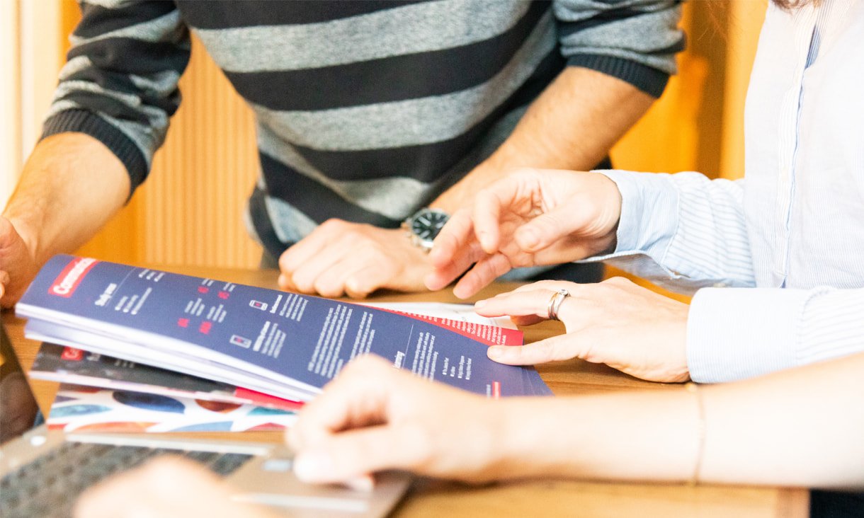 Parent and future student looking at RMIT branded booklet