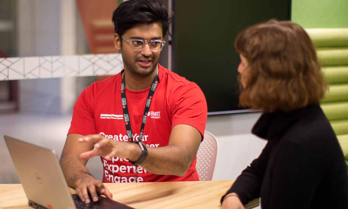 Job shop employee helping student