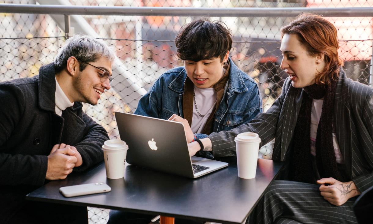 Male student wearing personal protective gear holding hammer to hit nail into wood frames.